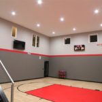 Eden Prairie_Indoor Basketball Court Featuring SnapSports Revolution Tuffshield Light Maple and Red athletic flooring tiles