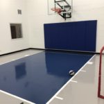 Twin Cities Spring Parade of Homes indoor basketball court featuring an epoxy floor in gray and dark blue installed by Millz House