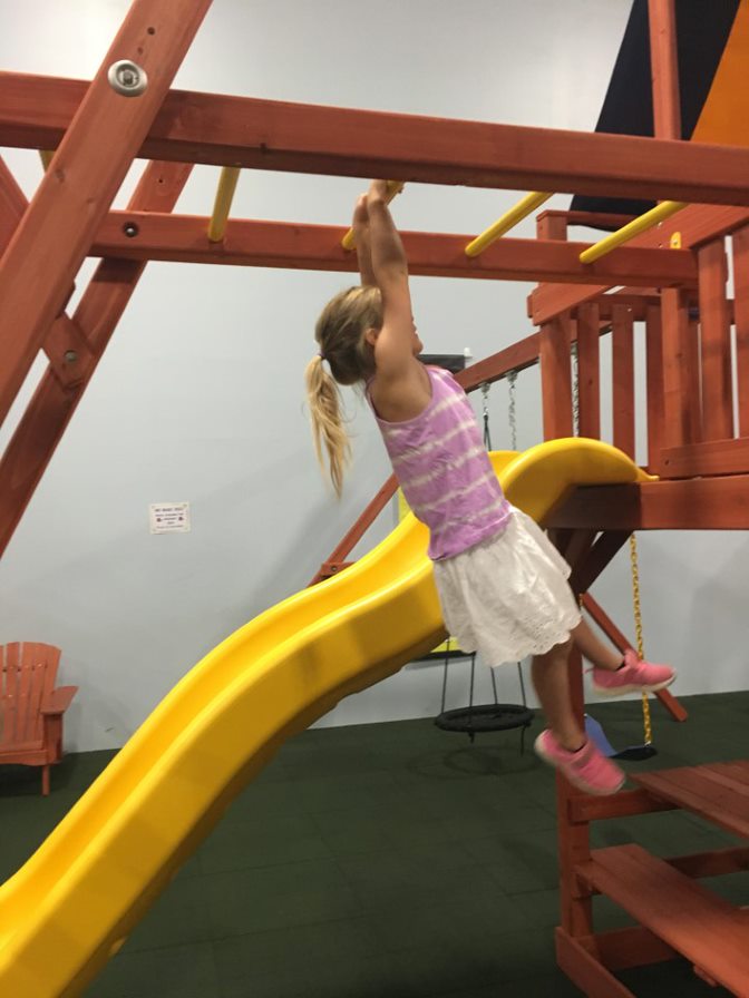 Child playing on monkey bars at Millz House Showroom in Apple Valley