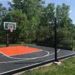 26'x 28' Outdoor Basketball Court with SnapSports Duracourt Athletic Tiles in Graphite with an Orange Lane and Black Border, 60" Gladiator Hoop with Pole Pad and Backboard Pad, White Game Lines,
10'x 20' Rebounder, Removable Game Pole with Multi-game Net and Winch