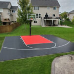 28' x 28' basketball court featuring SnapSports DuraCourt in black and red